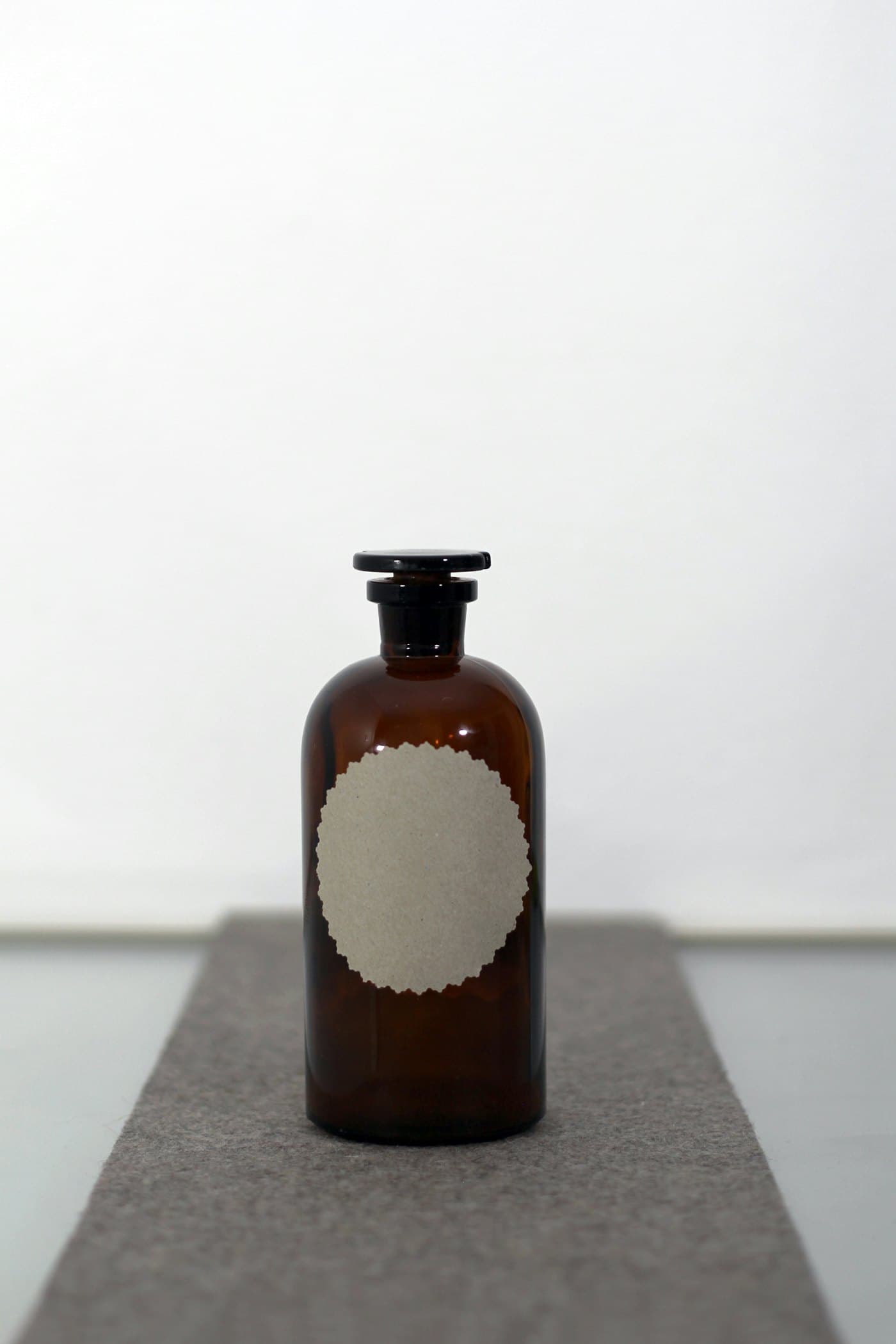 Amber glass bottle of liquid plant food with a plain label