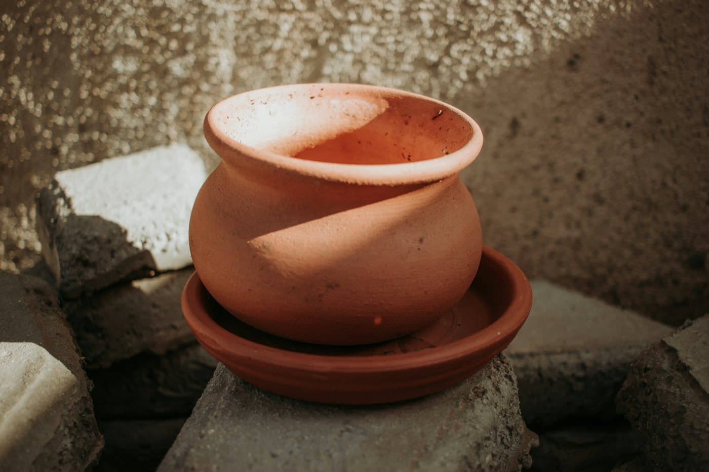 Unglazed terracotta pot with matching saucer